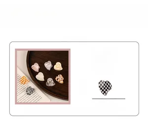 Close-up of 3cm mini acetate heart hair claws in checkered and marble patterns