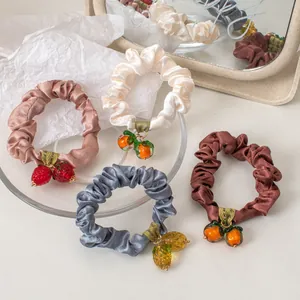 Satin scrunchies set with realistic fruit pendants in pink, white, grey and brown colors