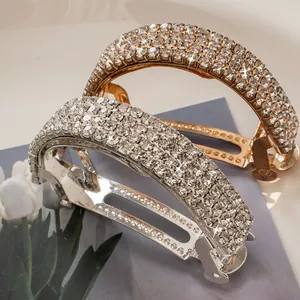 Elegant rhinestone curved spring hair clip in gold and silver finish with sparkling crystals