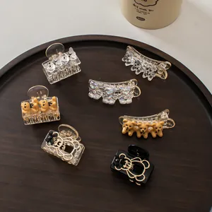Detailed collection of bear hair clips in various colors and styles on a tray