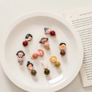 Flat lay of creative cartoon character hair clips set in a white ceramic dish