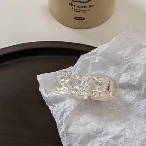 Detail of three resin bears hair claw clip with pearlescent finish and gold metal spring