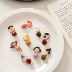Set of 9 colorful cartoon figure hair clips with Morandi beads on white plate