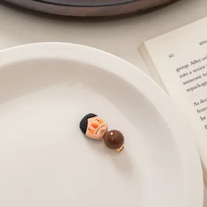 Close-up of a cute cartoon character hair clip on an ivory plate with vintage book