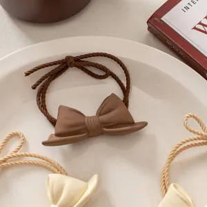 3-piece set of matte bow hair ties in coffee and cream colors for elegant hair styling