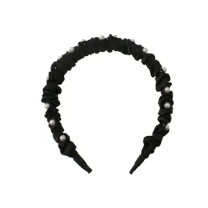 Elegant black pleated headband for women featuring white pearl embellishments on a wide band