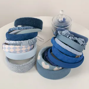 Collection of Klein blue sponge headbands in various plush and knitted textures