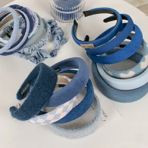 Collection of blue velvet and knitted sponge headbands with handmade decorative labels