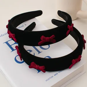 Retro black velvet headbands featuring small red bows and soft sponge padding style