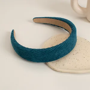 Detailed view of dark blue corduroy padded headband with soft non-slip velvet lining