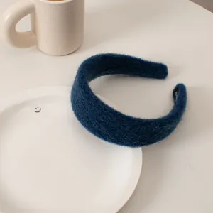 Detailed view of dark blue plush knit headband with soft texture and sponge filling