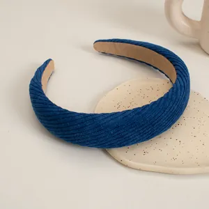 Detailed close-up of dark blue corduroy padded headband with soft non-slip velvet lining