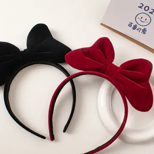 Elegant red and black velvet bow headbands for women in a minimalist aesthetic setting