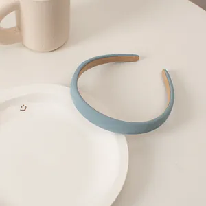 Detail of light blue headband featuring a herringbone fabric texture on a ceramic tray