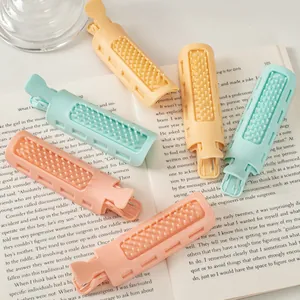 Close-up of pastel macaron hair root clips with fine comb teeth and strong spring