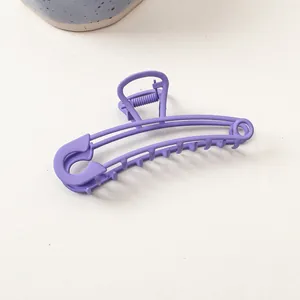 Détail d'une pince à cheveux mate bleu pervenche au design créatif d'épingle de sûreté