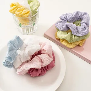 Close-up of colorful seersucker scrunchies set with checkered texture for hair styling