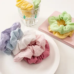 Detail of seersucker scrunchies showing textured fabric in various candy colors