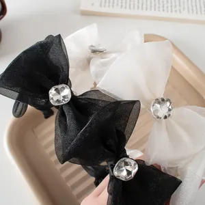 Detail of mesh bow headbands with square rhinestones in black and white styles