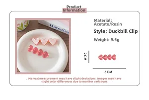 Detailed view of pink acetate heart hair clips with marble texture and dimensions