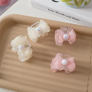Elegant 4-piece set of mesh bow hair claws with iridescent pearls in cream and soft pink