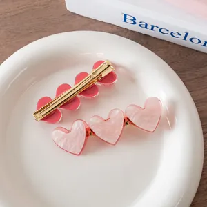 Pink heart acetate hair clips set with marble texture and golden metal duckbill pins