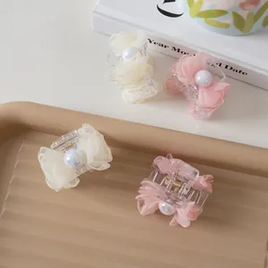 Set of 4 mini pearl and mesh bow hair claws in cream white and soft pink colors