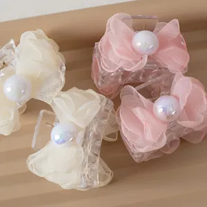 Elegant tulle bow hair clips with large pearls in pink and beige, set of four pieces