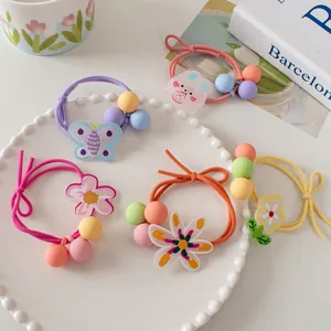 Close-up of five-piece candy-colored floral hair ties with acrylic charms and frosted beads