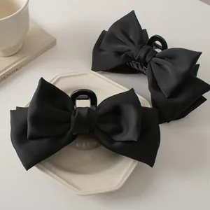 Elegant large black satin bow hair claw clips for women shown in a two-piece set