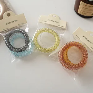 Transparent spiral hair ties set in assorted colors with elegant cardboard packaging