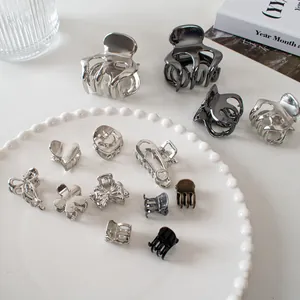 Detailed collection of mini metal hair claws in heart, bow and floral shapes