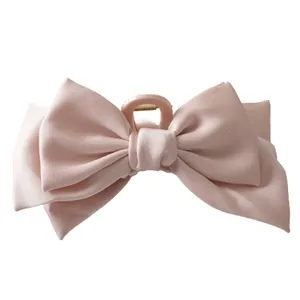 Large double-sided satin bow hair claw clip in elegant pale pink for high-end styling