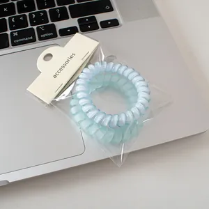 Primer plano de gomas de pelo en espiral esmeriladas azules y verdes en un teclado