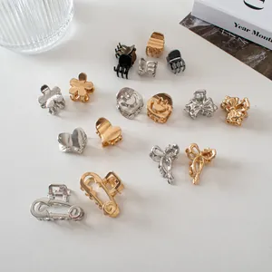 Collection of mini metal hair claw clips in assorted gold and silver fashion shapes