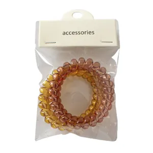 Two-piece set of transparent spiral telephone wire hair ties in amber and pale yellow