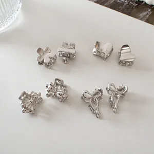 Mini silver metal hair claws set featuring flower, heart and bow designs for women