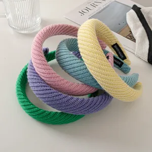 Detail showing colorful knitted headbands with handmade labels in a cozy lifestyle setting