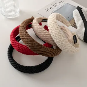 Detailed knit texture of handmade winter headbands in burgundy, black, beige and brown