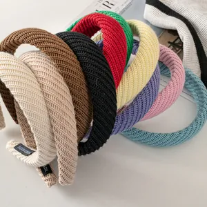 Macro detail of knit headbands with handmade tags in various winter colors