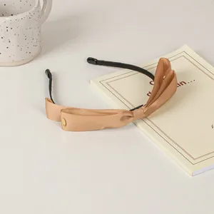 Elegant champagne gold double bow headband with ribbed ribbon texture and slim frame