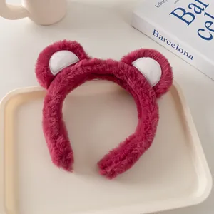 Primer plano de diadema de felpa rosa con orejas de oso en una bandeja decorativa