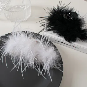 Detail view of fluffy ostrich feather hair claws in black and white for elegant styling