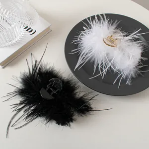 Detail of luxury white and black ostrich feather hair claws on a decorative display