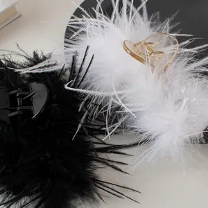 Macro shot of fluffy ostrich feather hair claws in elegant black and white colors