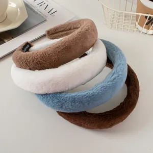 Detailed close-up of fluffy faux rabbit fur headbands with handmade fabric labels