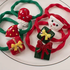Cute Santa and Christmas hat hair ties with high-elastic ribbed bands in a ceramic dish