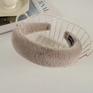 Detail of plush faux rabbit fur headband in light brown with handmade label inside