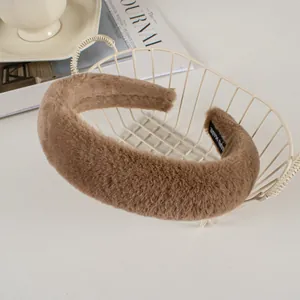 Detail of plush brown faux rabbit fur headband with handmade label in a decor basket