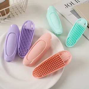 Silicone scalp massage brush detail in pastel colors with soft bristles and hand grip